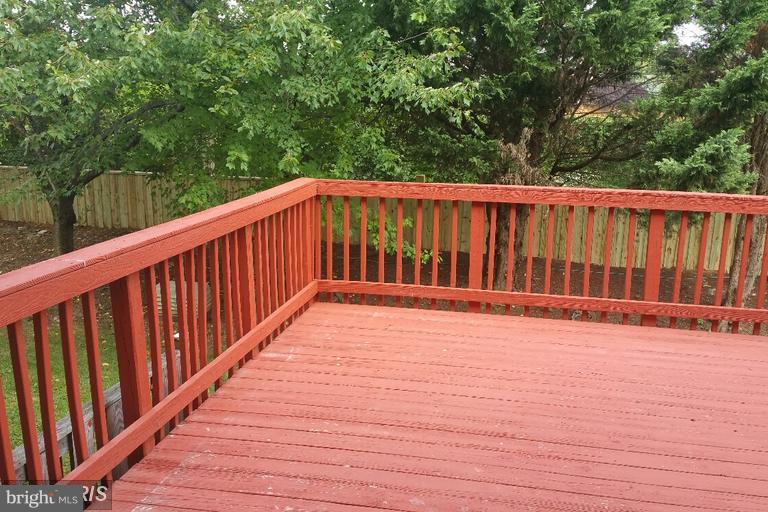 6367 Racetec Place Springfield, VA 22150 - Photo 21 of 25 a balcony with wooden floor and trees