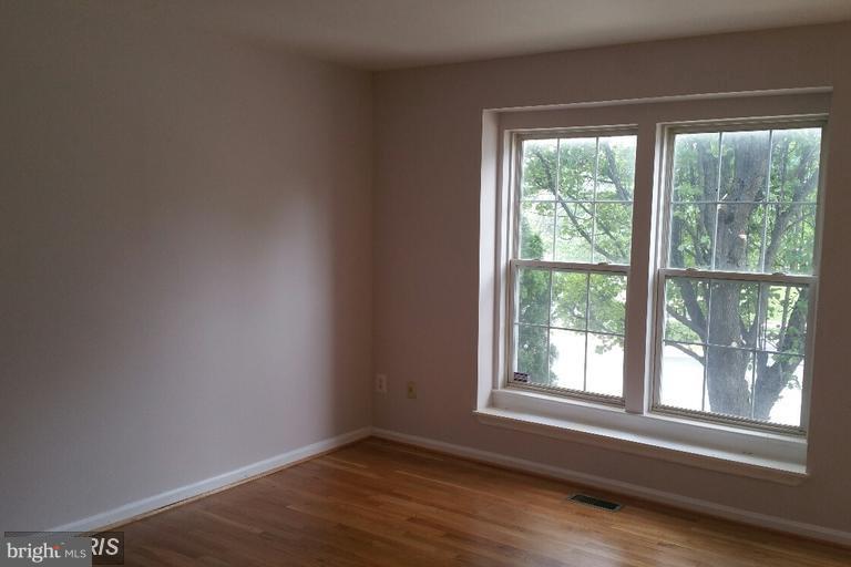 6367 Racetec Place Springfield, VA 22150 - Photo 25 of 25 a view of an empty room with wooden floor and a window