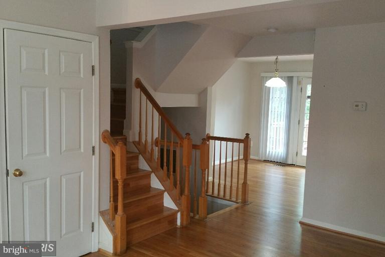 6367 Racetec Place Springfield, VA 22150 - Photo 4 of 25 a view of a hallway with wooden floor and staircase