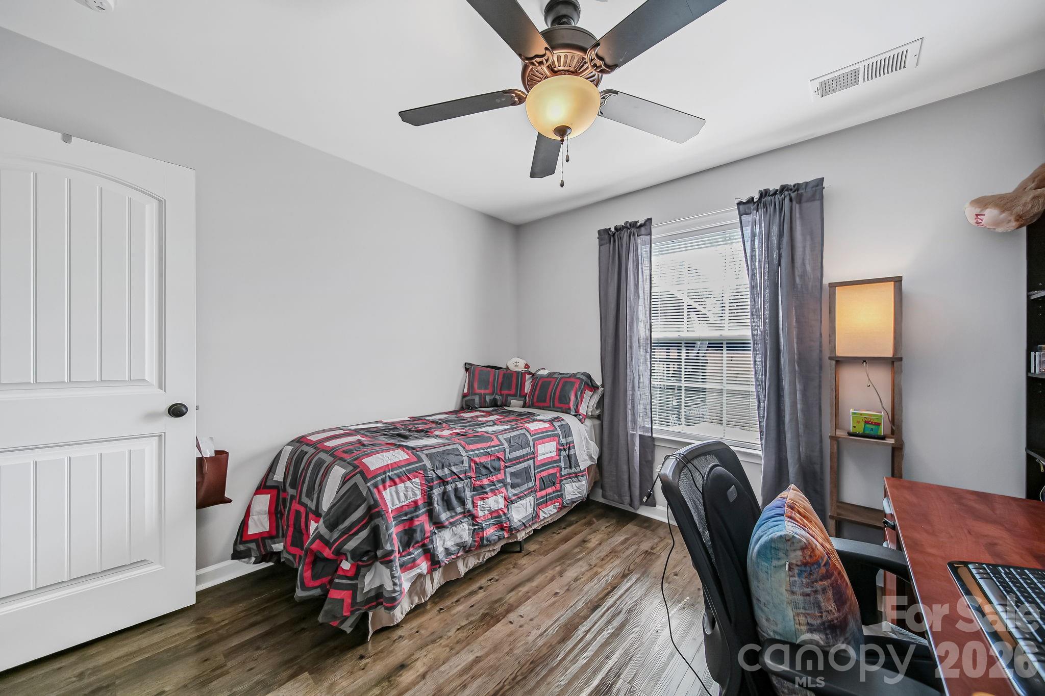 1189 West Elizabeth Street Pageland, SC 29728 - Photo 19 of 37 a bedroom that has a bed and a chandelier