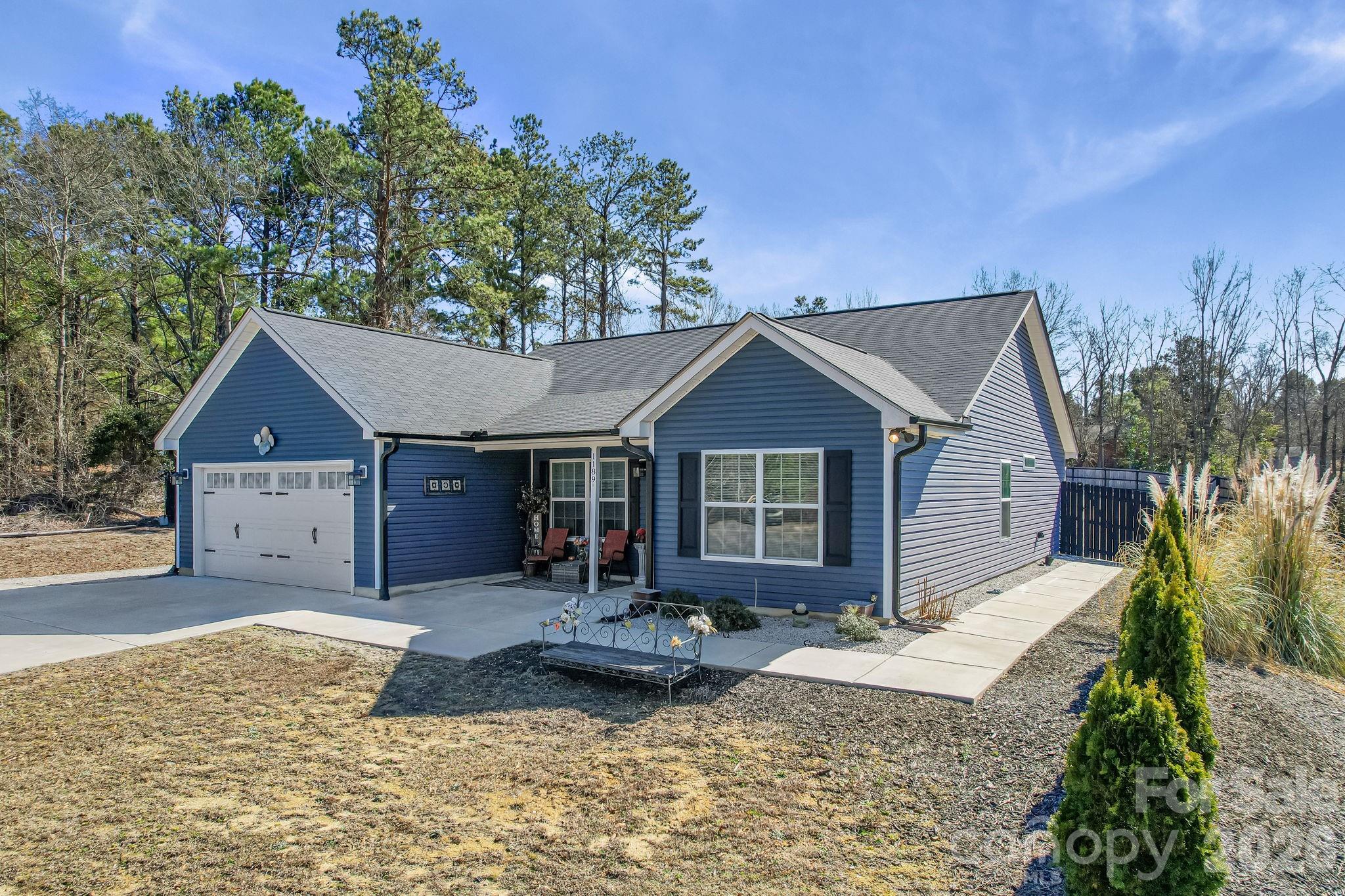 1189 West Elizabeth Street Pageland, SC 29728 - Photo 2 of 37 a front view of a house with a yard and garage