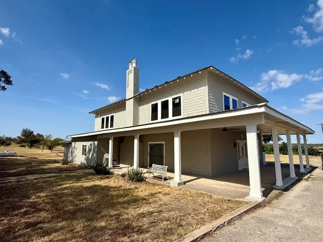 a front view of a house with a yard outdoor seating and garage