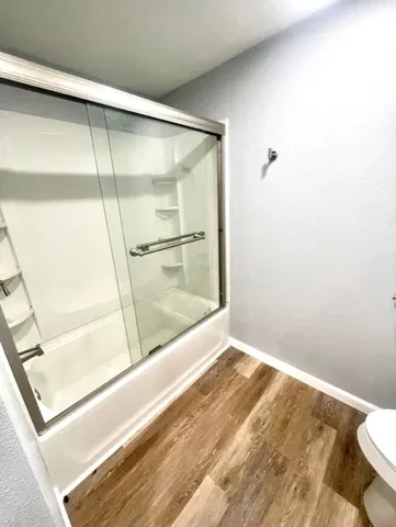 a kitchen with granite countertop a sink and white cabinets