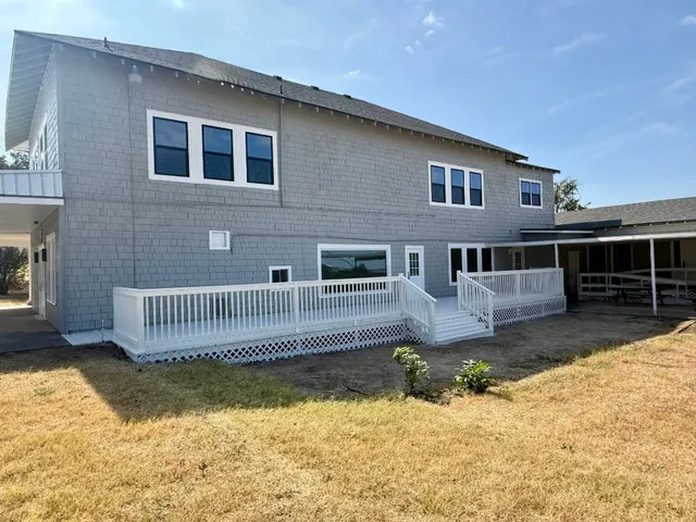 a front view of a house with a yard outdoor seating and garage