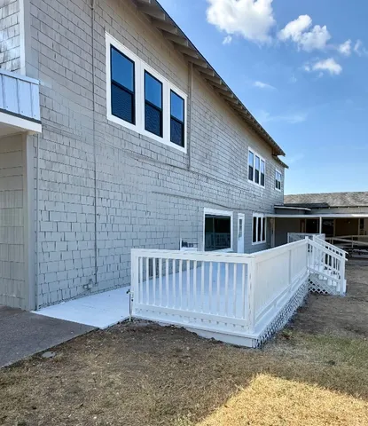 a view of a house with a wooden deck