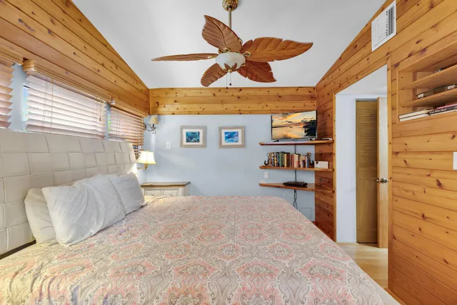 a bed room with a bed and a chair