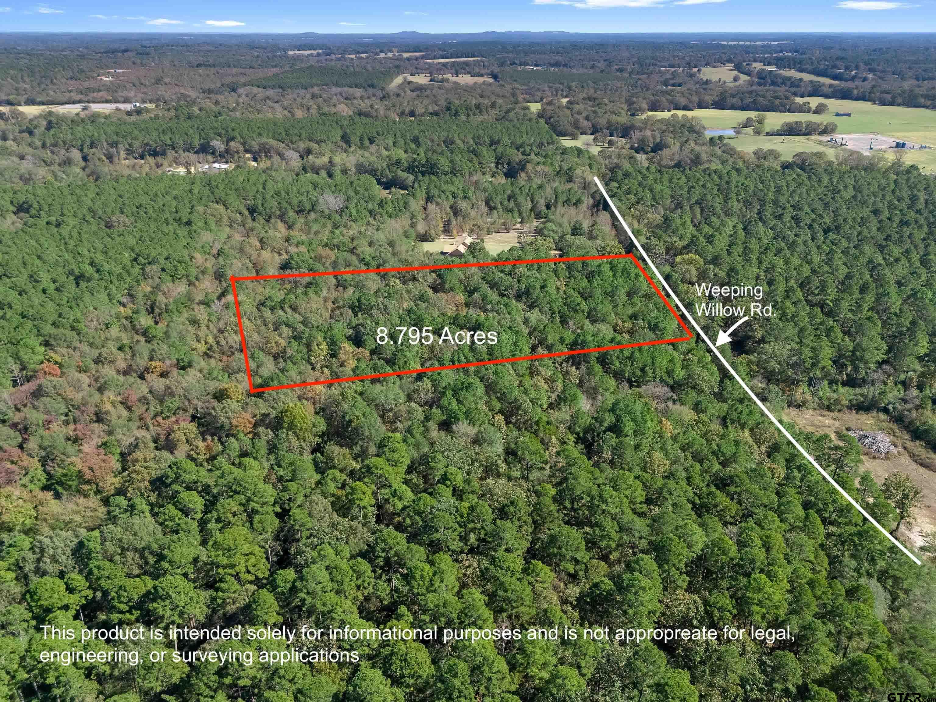 an aerial view of a houses with a lush green hillside