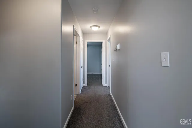 a view of hallway with wooden floor