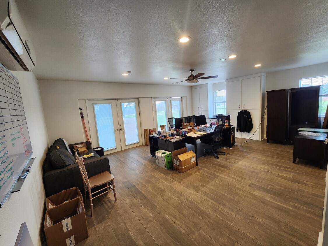 102 County Road 180 Leander, TX 78641 - Photo 10 of 25 A versatile open-concept space featuring wood-look flooring and ample built-in storage.