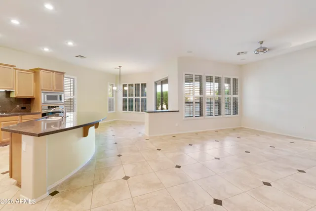 a view of a kitchen with granite countertop a sink and a stove top oven