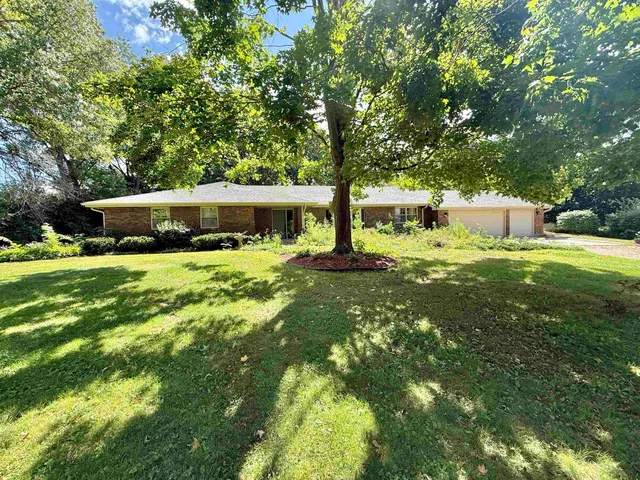 a view of a house with a yard porch and sitting area