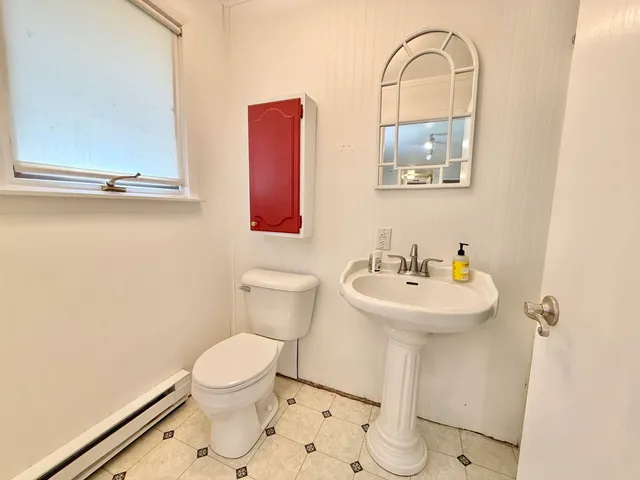 a white toilet sitting next to a bathroom sink