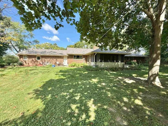 a house with swimming pool in front of it