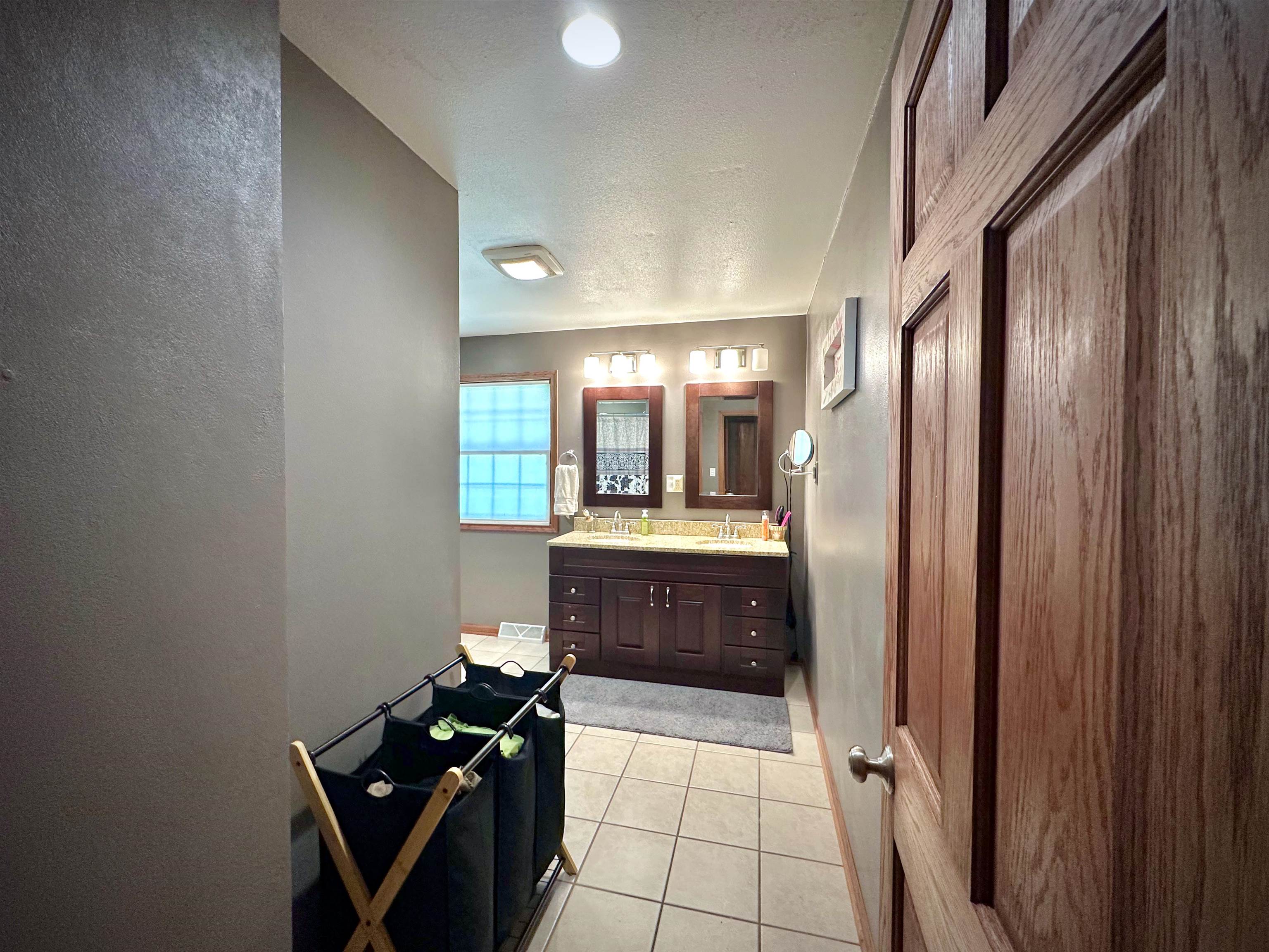 7356 Kishwaukee Road Rockford, IL 61109 - Photo 37 of 71 a bathroom with a glass door shower a sink and a mirror