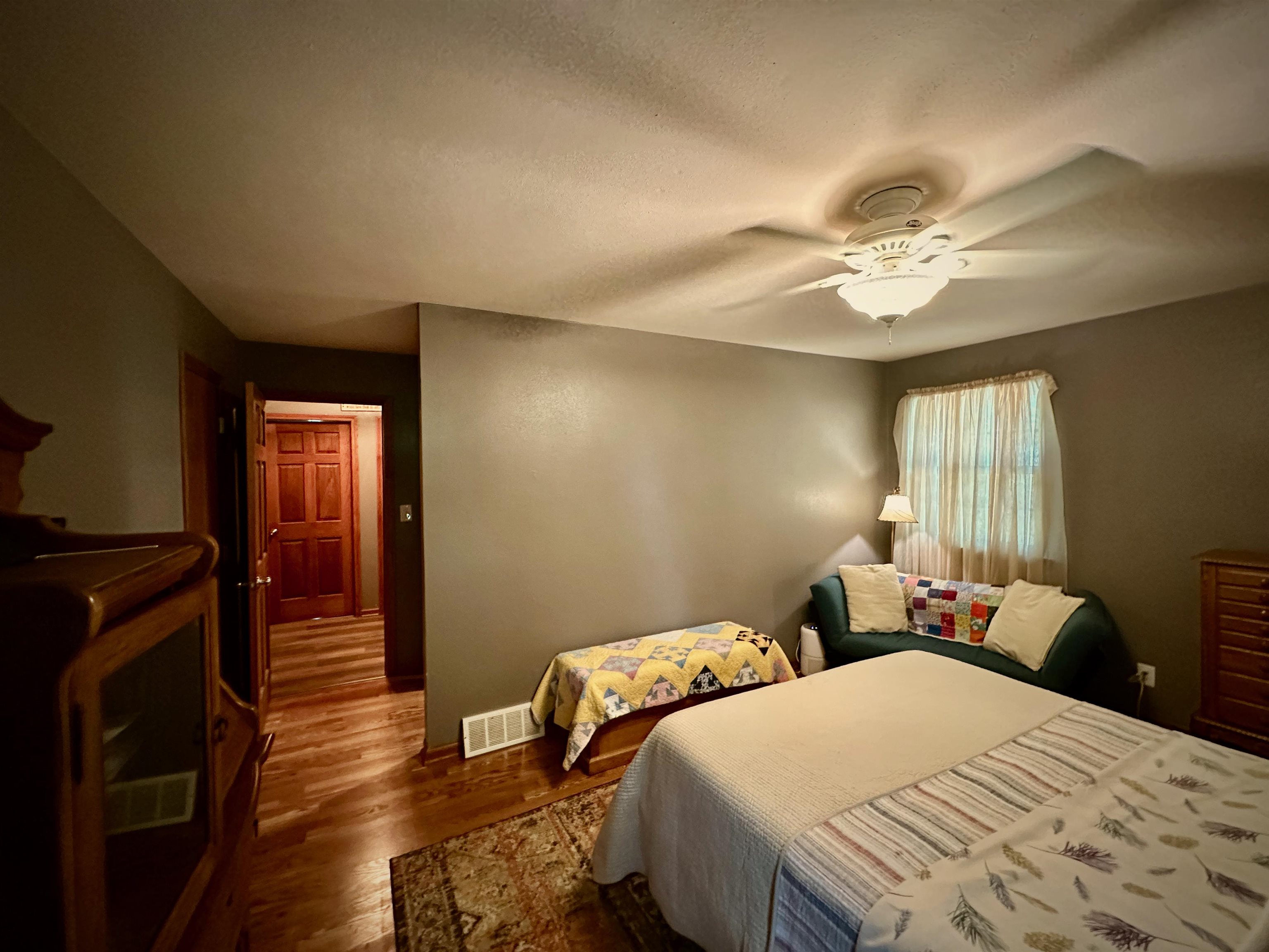 7356 Kishwaukee Road Rockford, IL 61109 - Photo 48 of 71 a bedroom with a bed and wooden floor