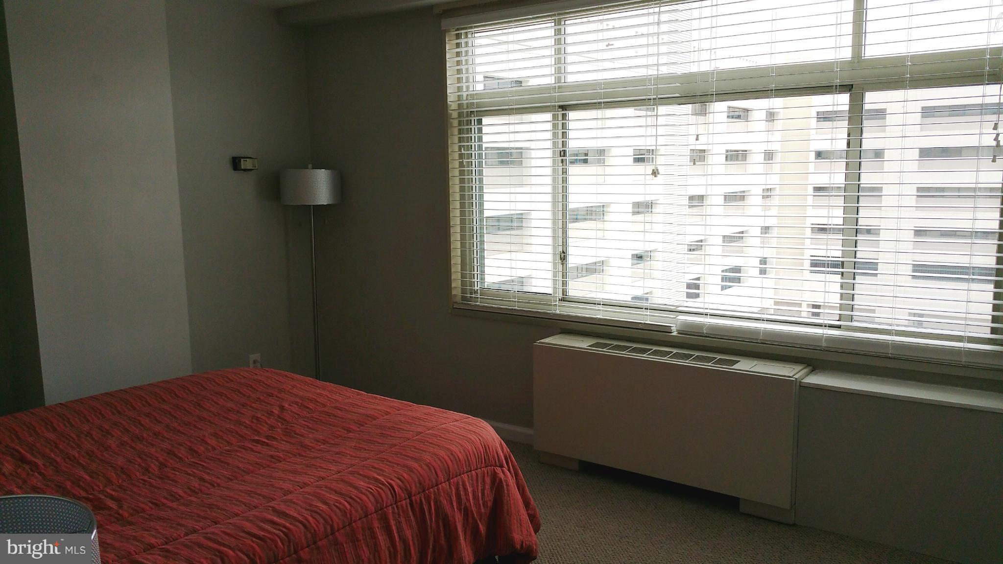 2401 H Street Northwest, Unit 904 Washington, DC 20037 - Photo 14 of 25 a bedroom with a bed and a window