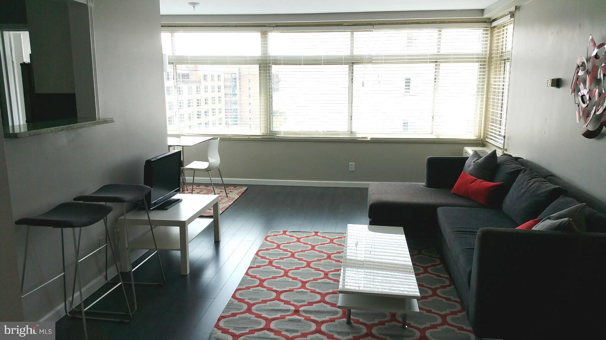 2401 H Street Northwest, Unit 904 Washington, DC 20037 - Photo 3 of 25 a living room with furniture and a window
