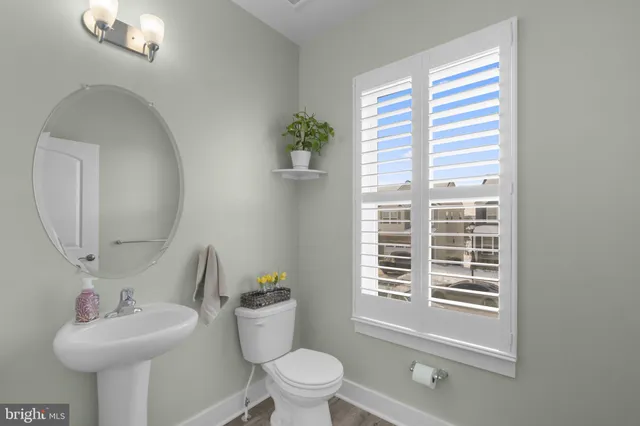 a bathroom with a sink toilet and a mirror