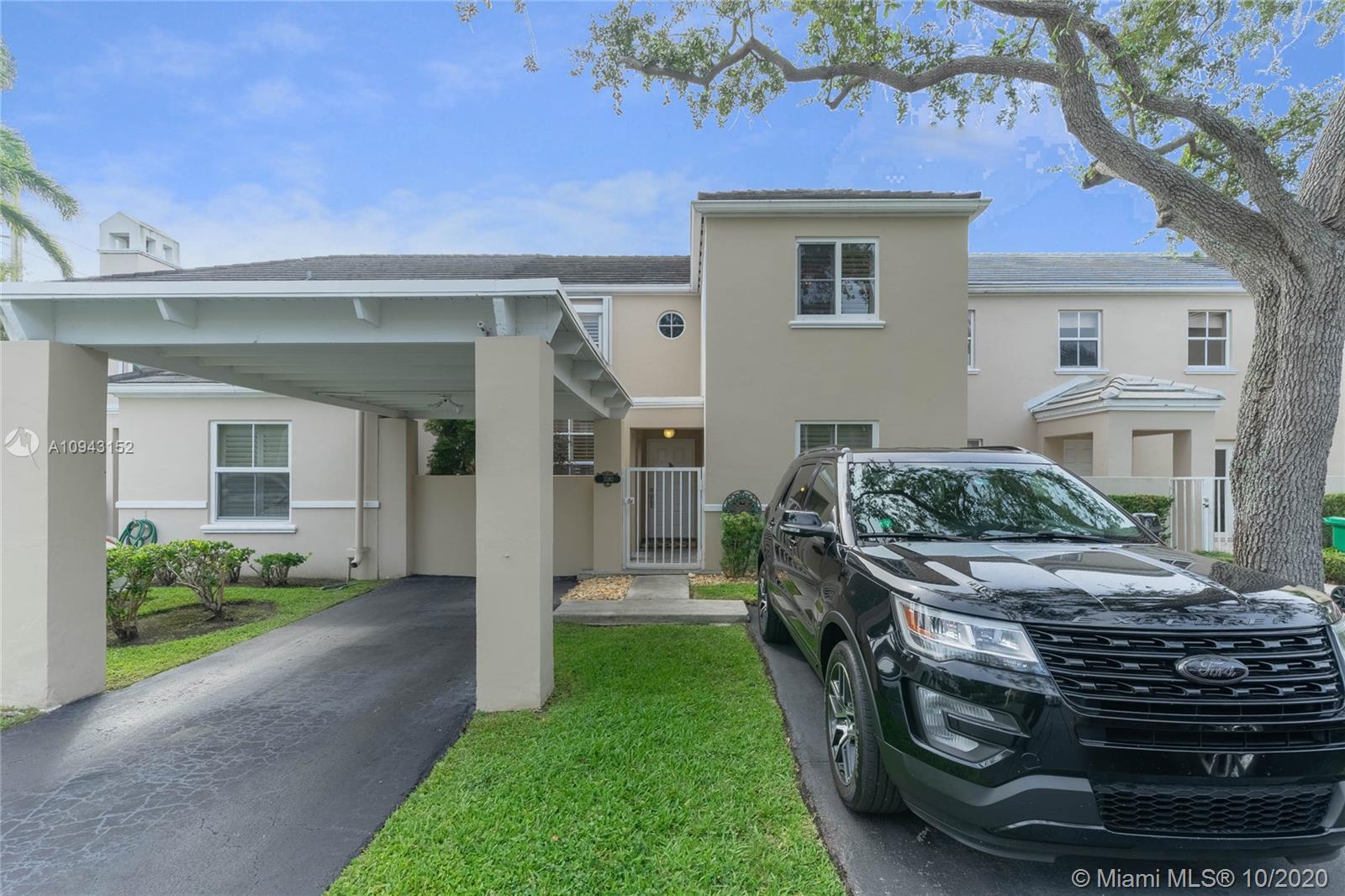 5580 Southwest 70th Place South Miami, FL 33155 - Photo 2 of 13 a front view of a house with garden