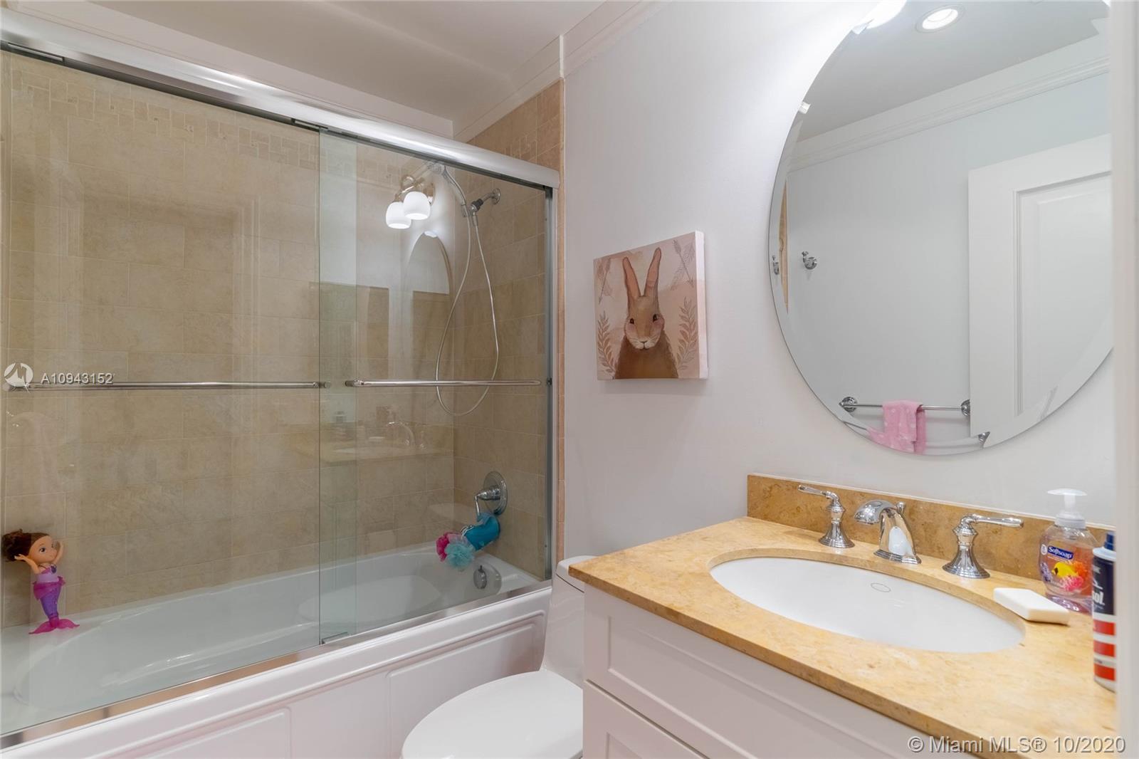 5580 Southwest 70th Place South Miami, FL 33155 - Photo 11 of 13 a bathroom with a granite countertop sink mirror toilet and bathtub