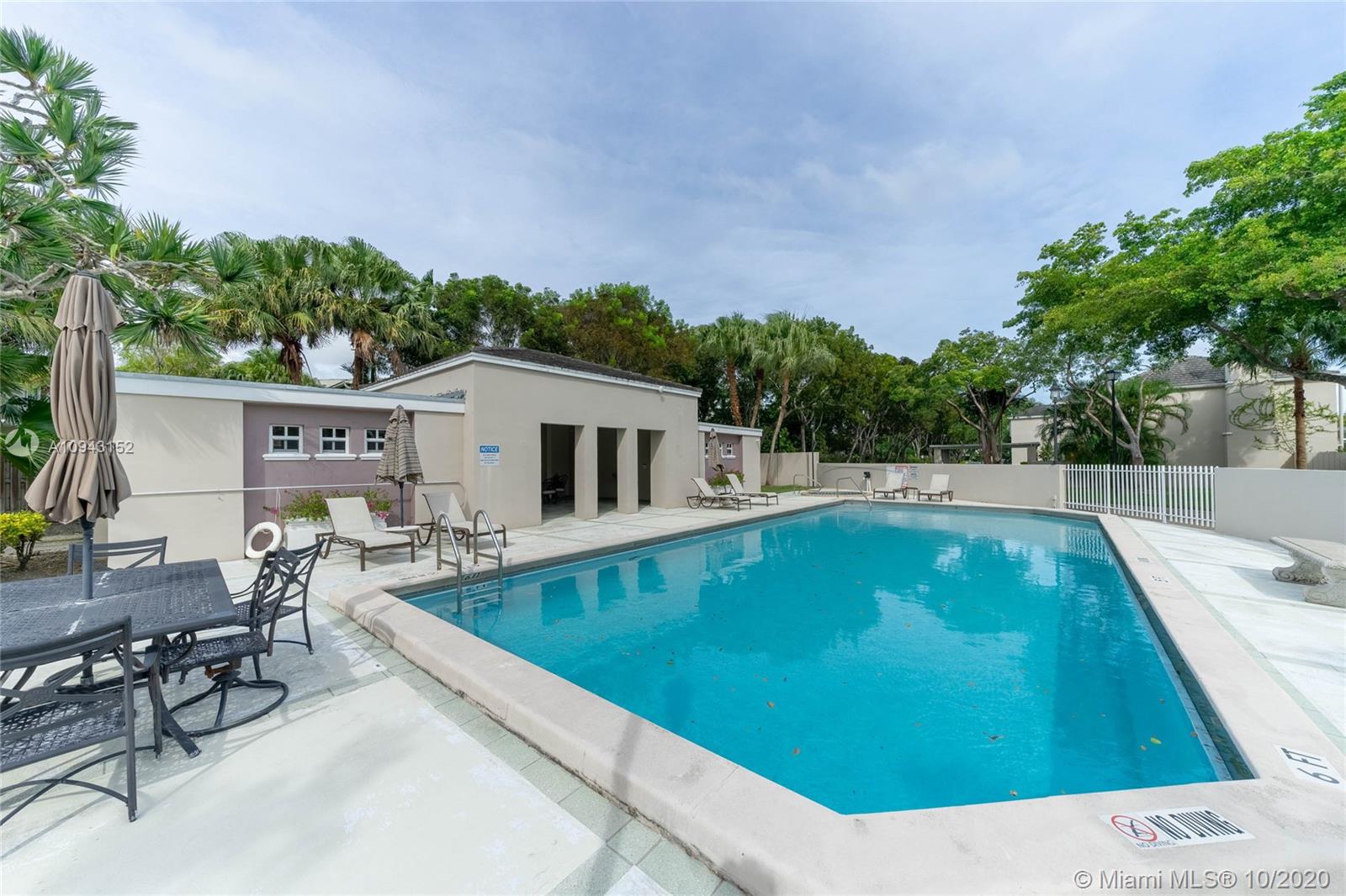 5580 Southwest 70th Place South Miami, FL 33155 - Photo 13 of 13 a view of a swimming pool with outdoor seating and plants