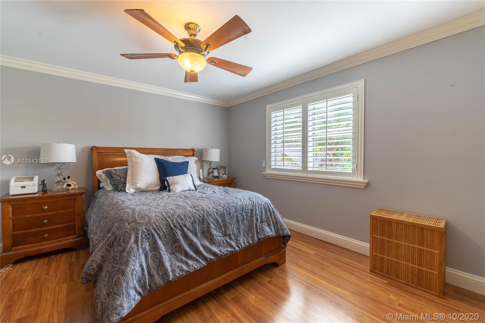 5580 Southwest 70th Place South Miami, FL 33155 - Photo 8 of 13 a bedroom with a bed and window