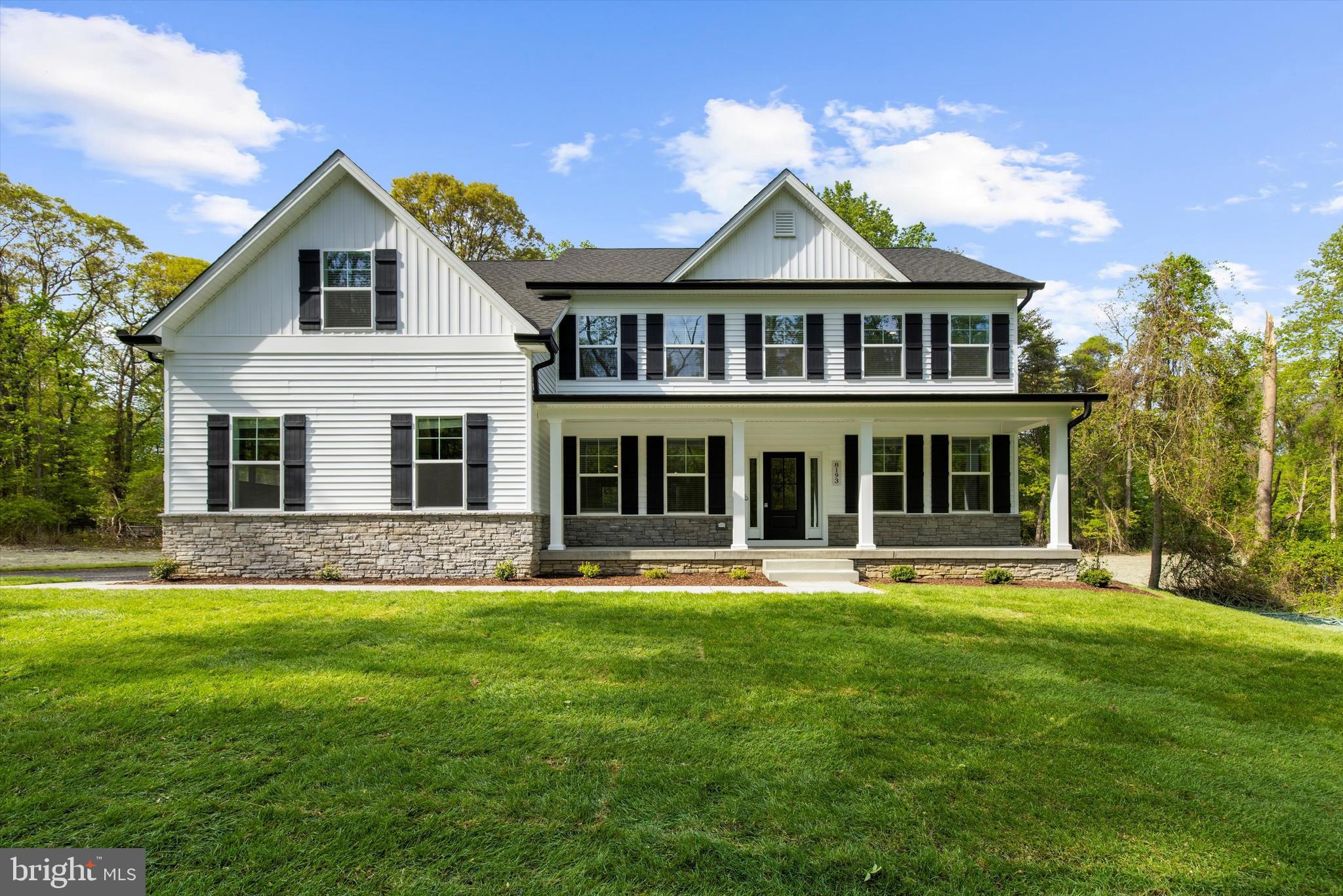 a front view of a house with a yard table and chairs