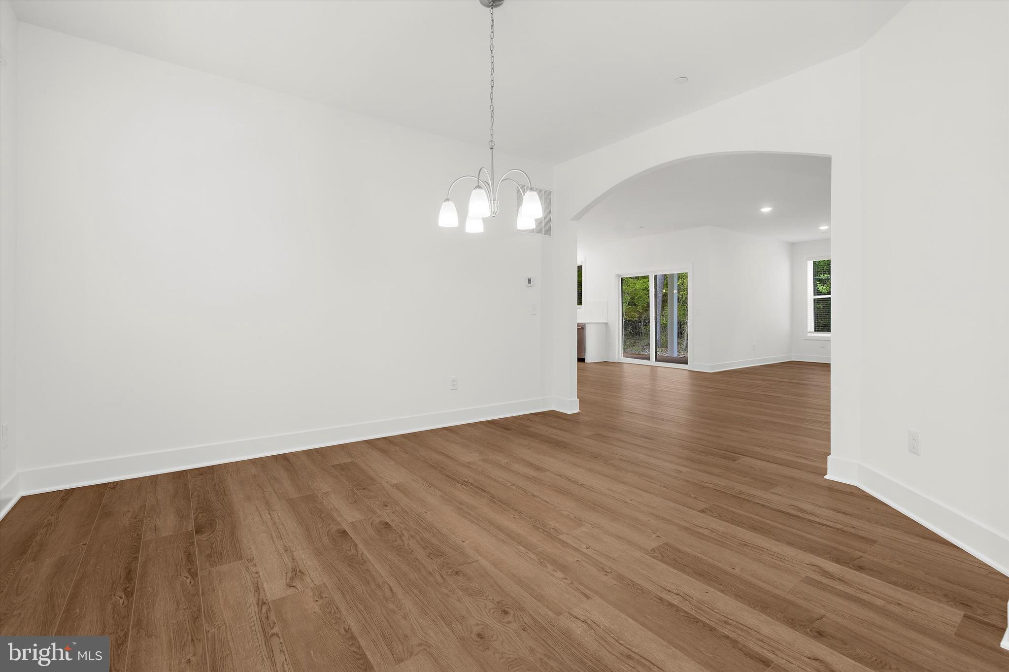 1807 Mountain Bay Road Pasadena, MD 21122 - Photo 14 of 75 a view of a room with wooden floor and white walls