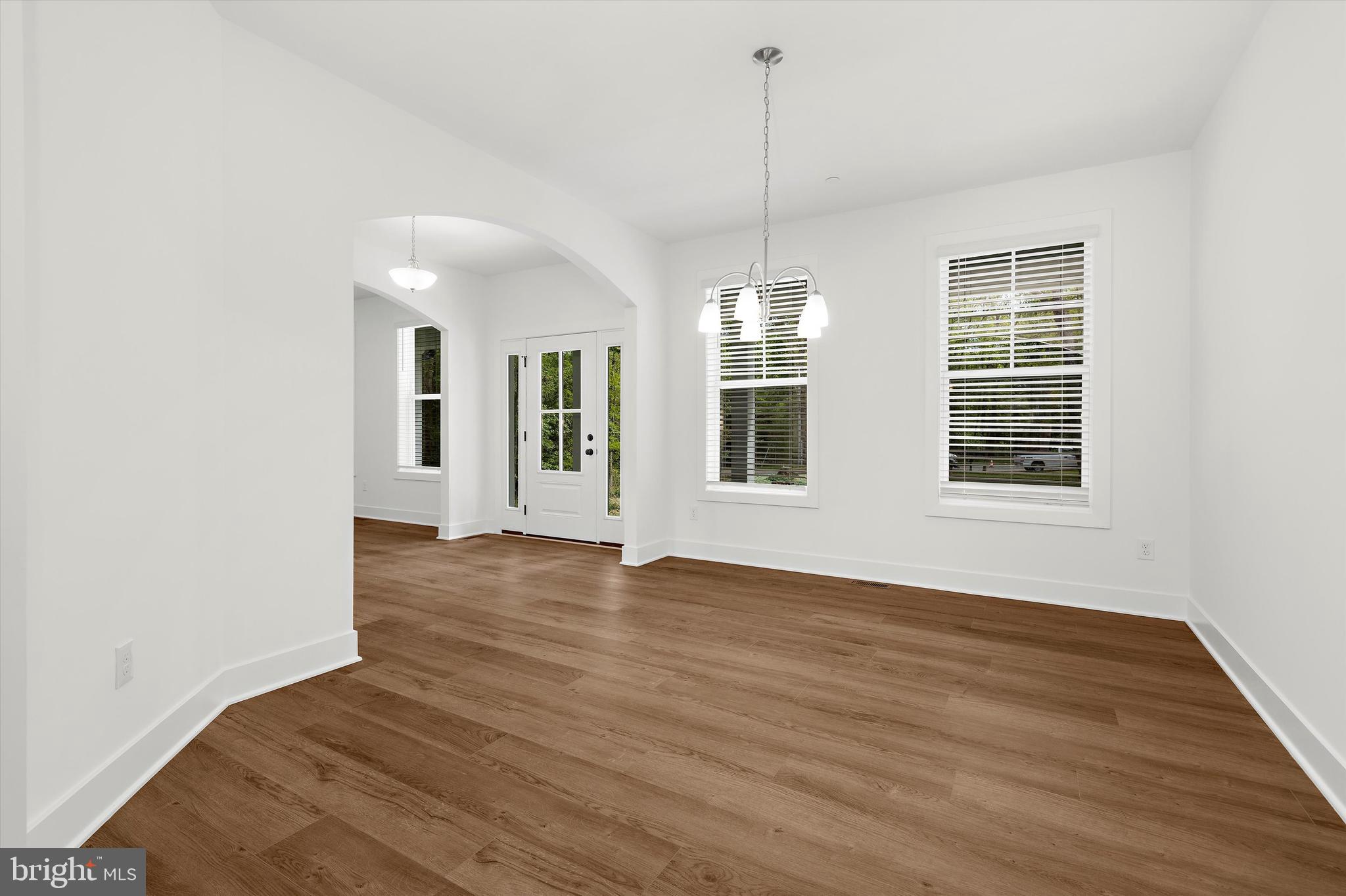 1807 Mountain Bay Road Pasadena, MD 21122 - Photo 16 of 75 a view of an empty room with wooden floor and a window