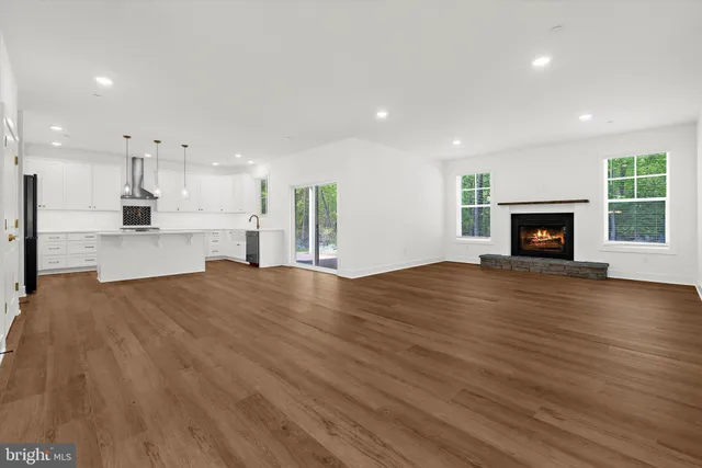 a kitchen with granite countertop white cabinets and window