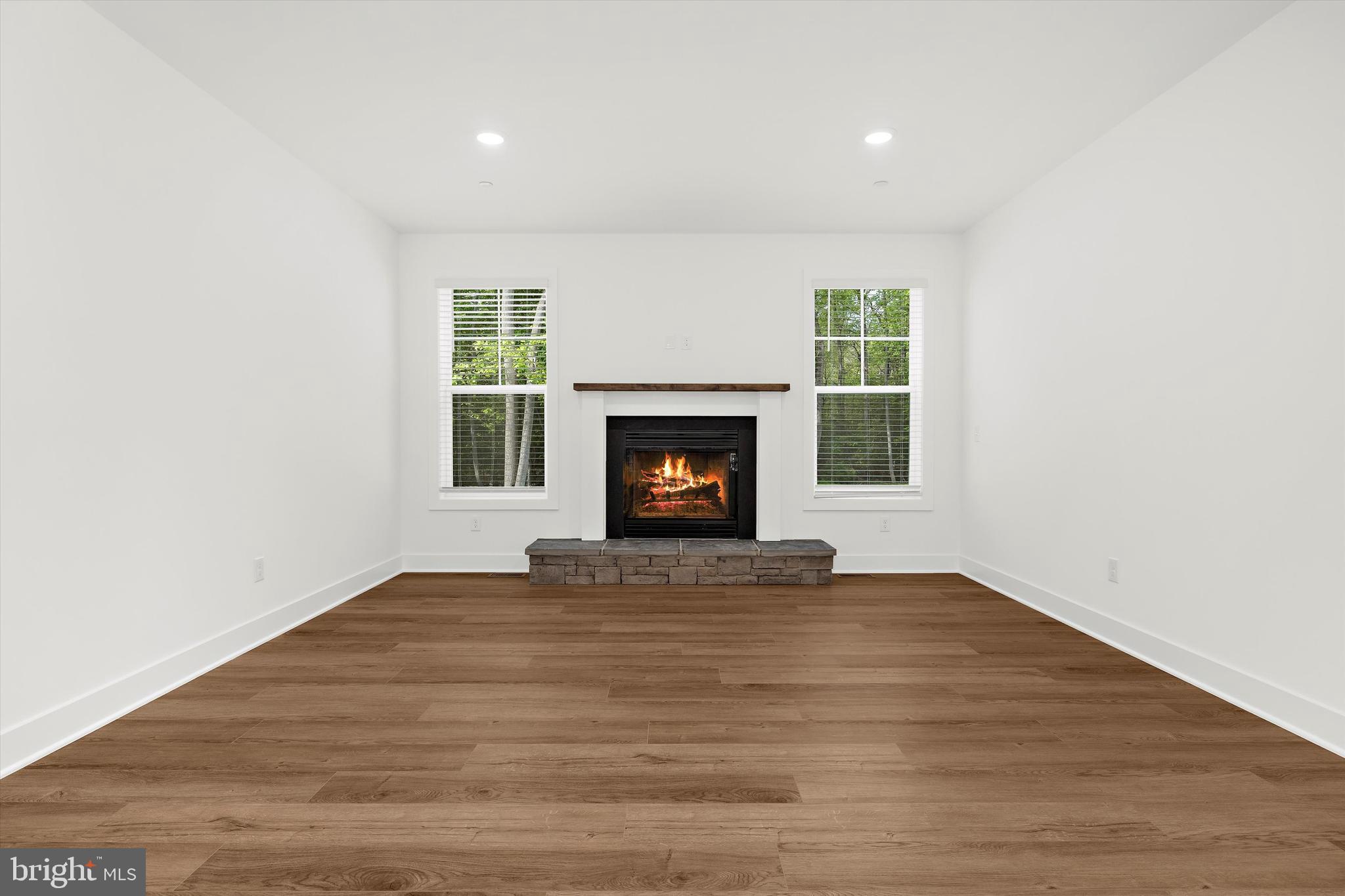 1807 Mountain Bay Road Pasadena, MD 21122 - Photo 19 of 75 a view of an empty room with wooden floor fireplace and a window
