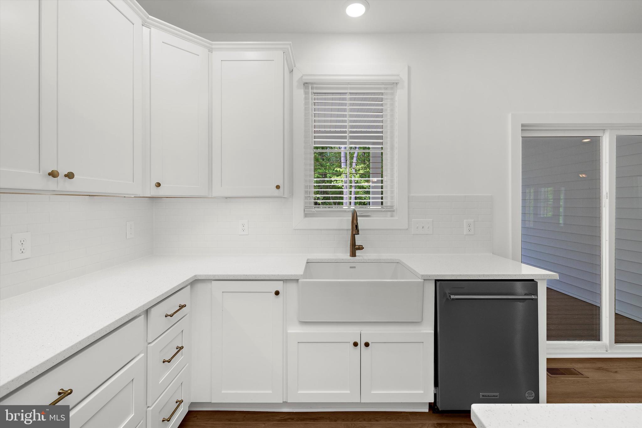 1807 Mountain Bay Road Pasadena, MD 21122 - Photo 23 of 75 a kitchen with granite countertop white cabinets and window