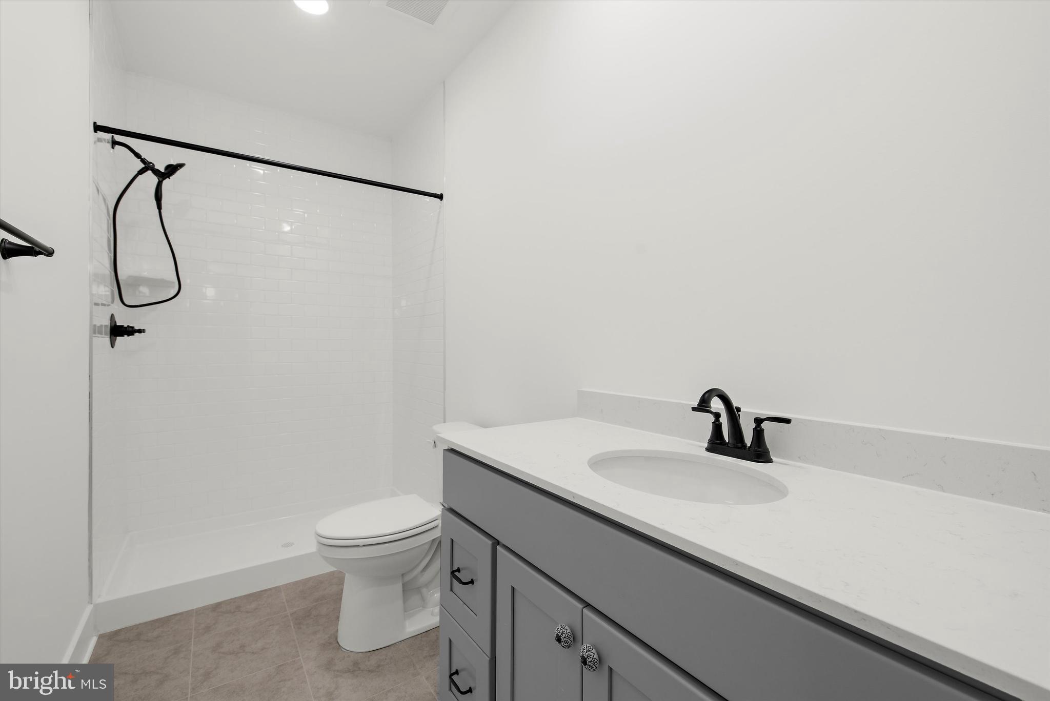 1807 Mountain Bay Road Pasadena, MD 21122 - Photo 31 of 75 a bathroom with a sink a toilet and a shower