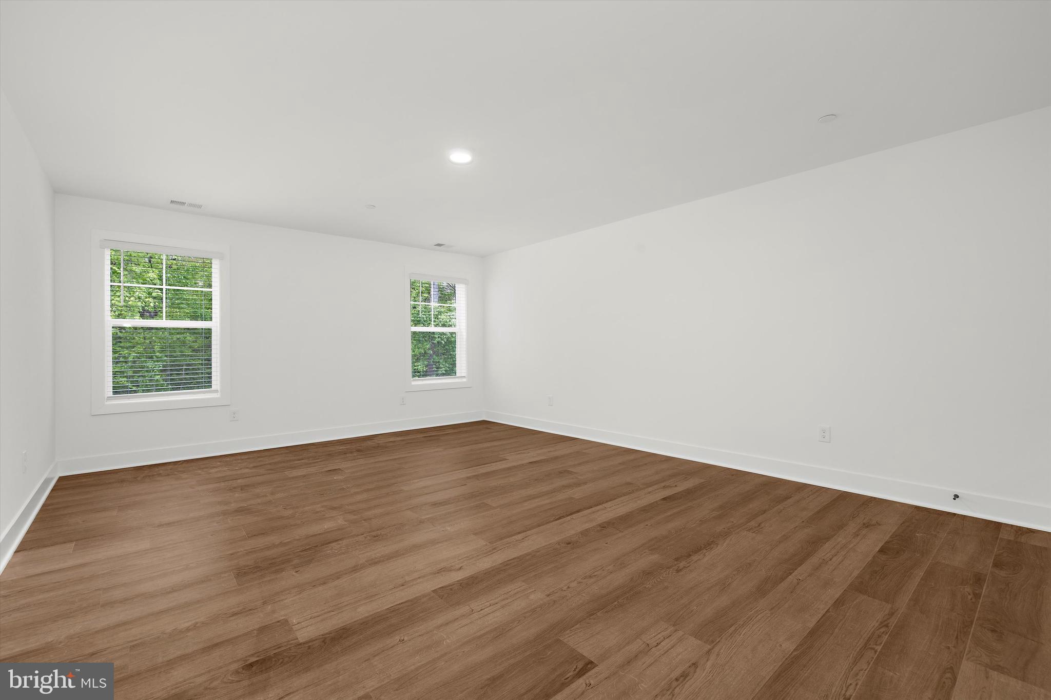 1807 Mountain Bay Road Pasadena, MD 21122 - Photo 44 of 75 an empty room with wooden floor and windows