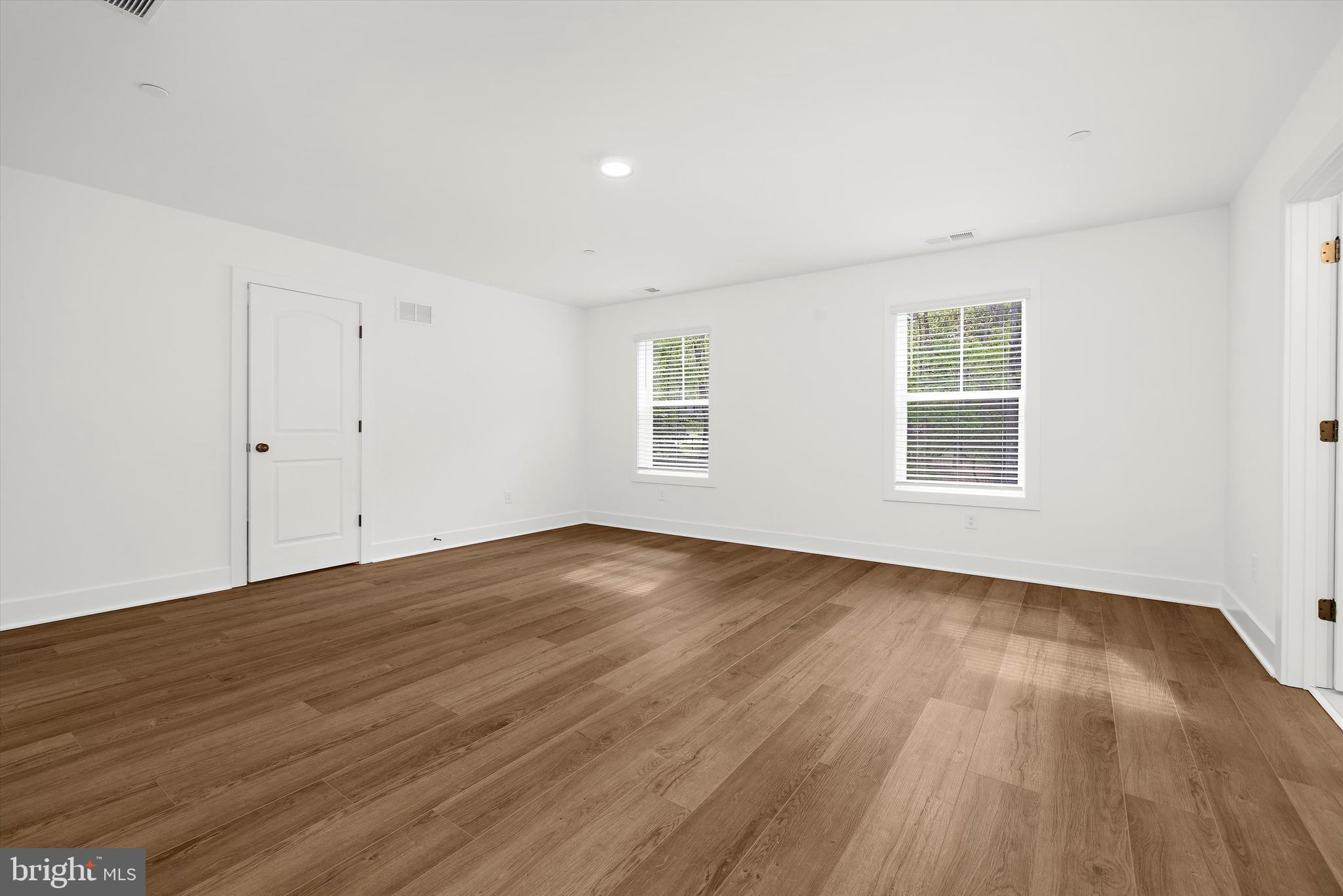 1807 Mountain Bay Road Pasadena, MD 21122 - Photo 48 of 75 an empty room with wooden floor and windows