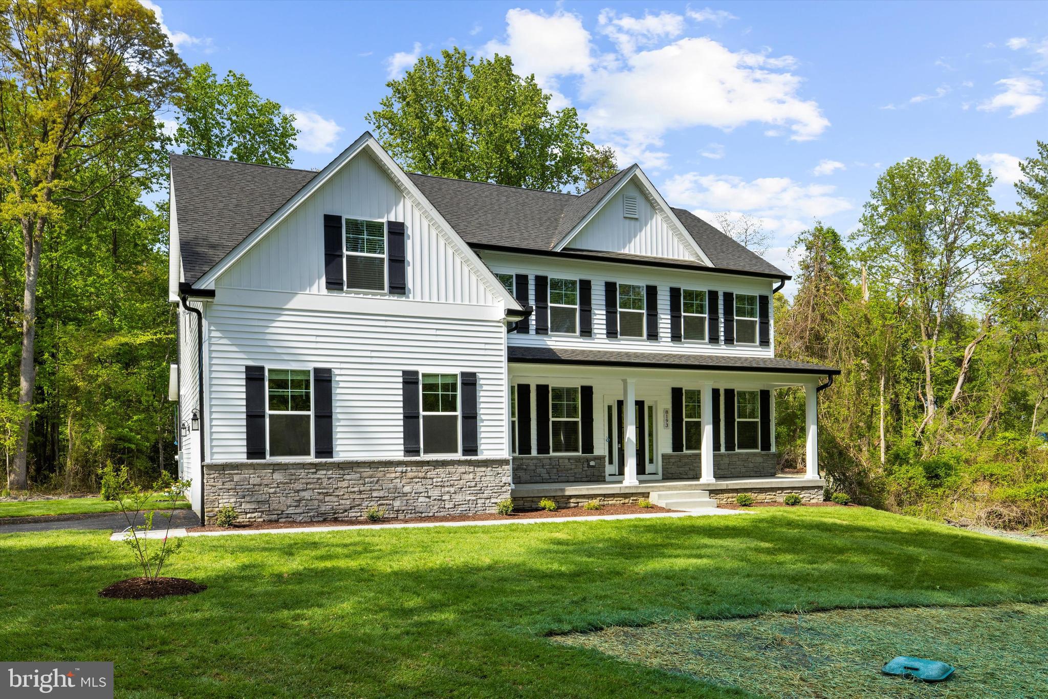 1807 Mountain Bay Road Pasadena, MD 21122 - Photo 6 of 75 a front view of a house with a garden