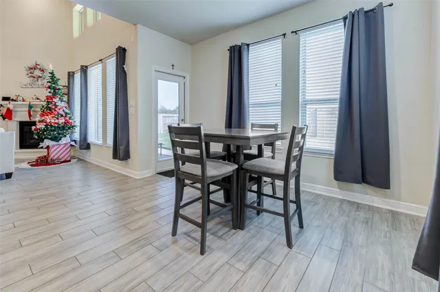 a view of a dining room with furniture and wooden floor