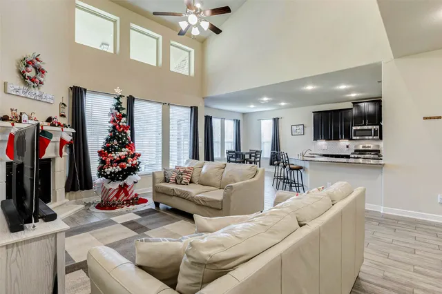 a living room with furniture and a chandelier