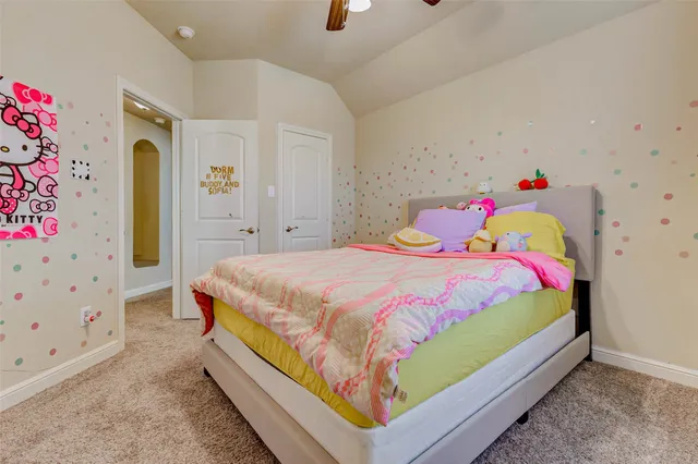 a large bed sitting in a bedroom next to a window