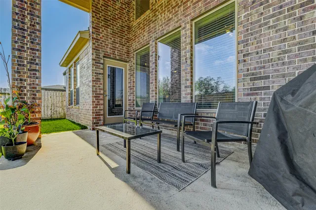 a view of a patio with table and chairs and potted plants