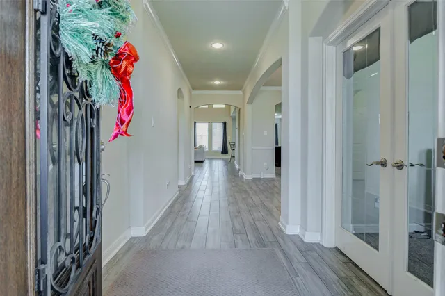a view of a hallway with wooden floor and closet