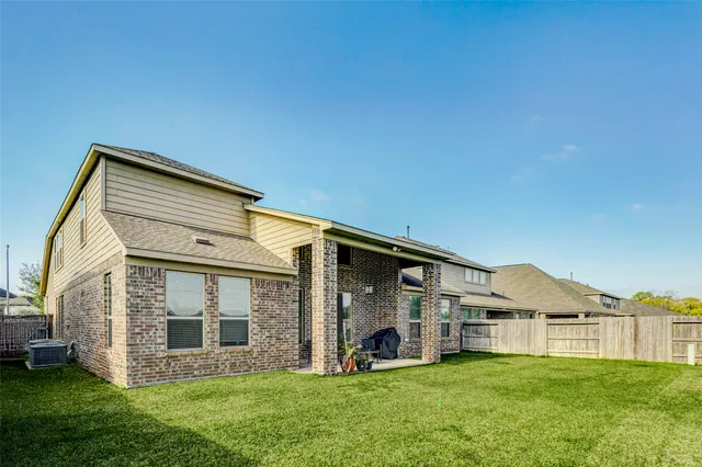 a view of a house with a yard and sitting area