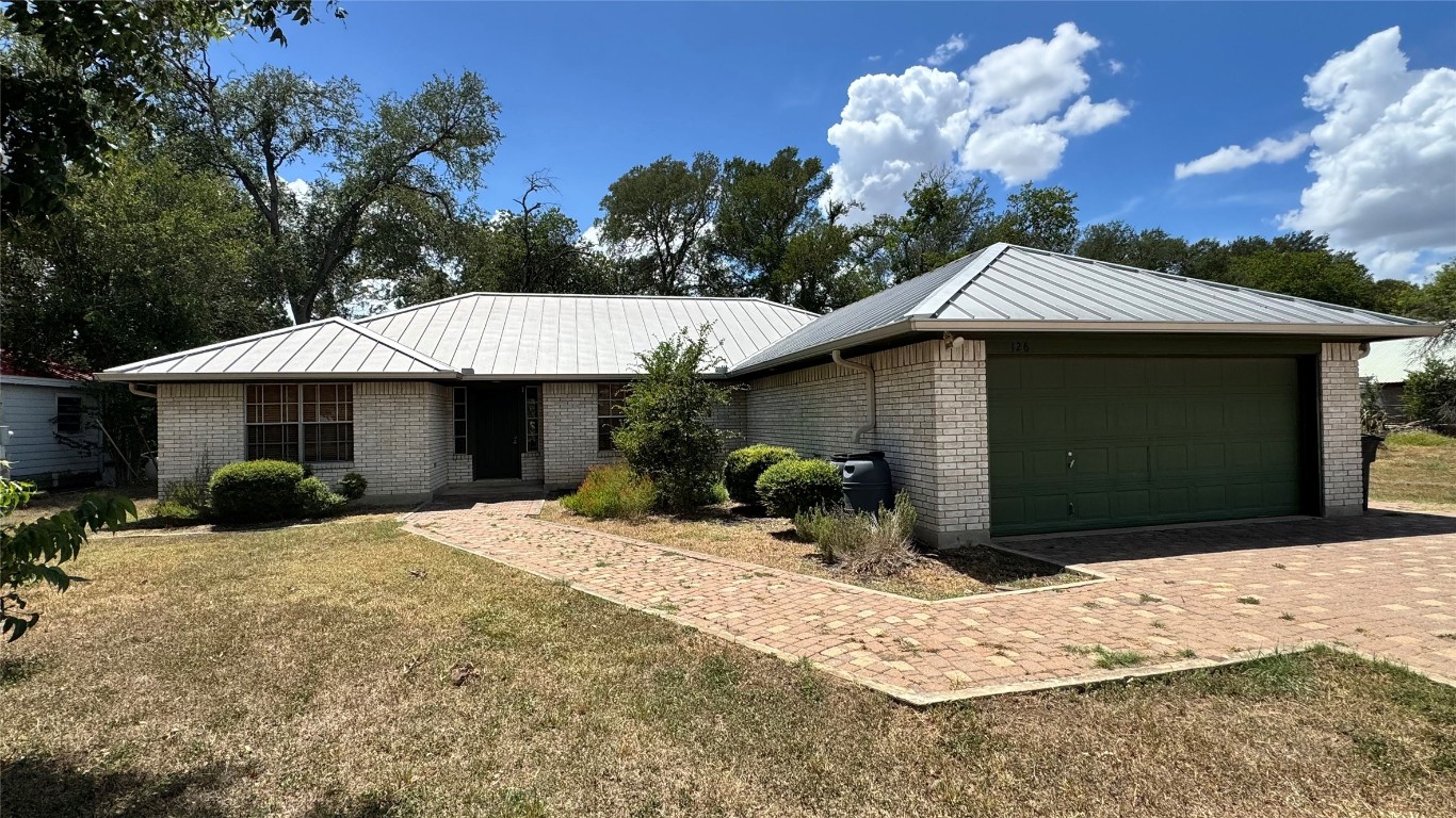 a view of a house with a yard covered in snow