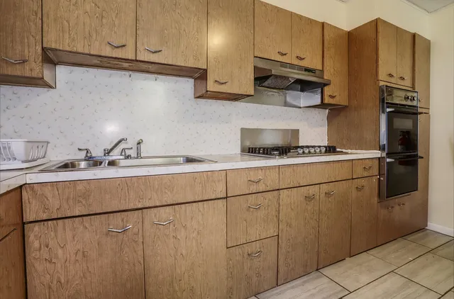a kitchen with stainless steel appliances granite countertop a refrigerator sink and cabinets