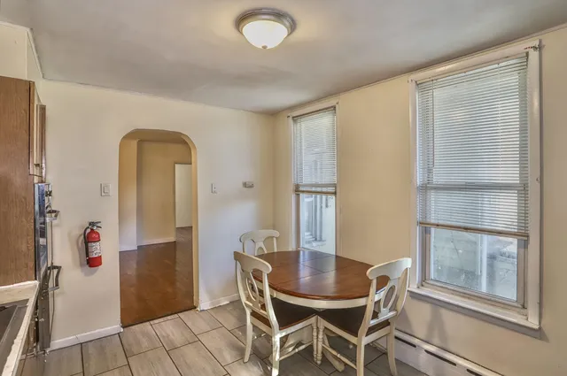 a view of a dining room with furniture and a window