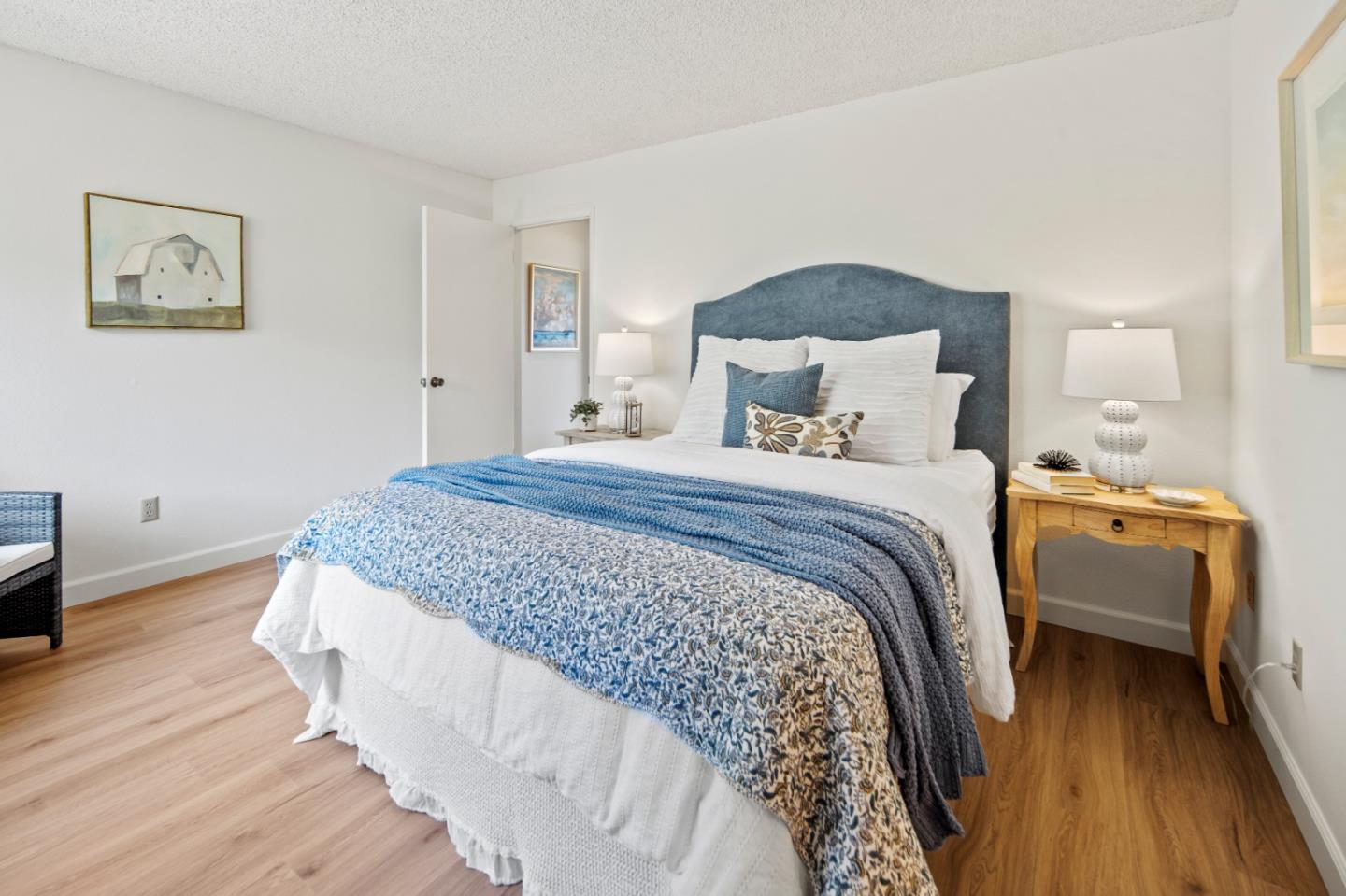 70 Forest Ridge Road, Unit 22 Monterey, CA 93940 - Photo 8 of 13 a bedroom with a bed and wooden floor