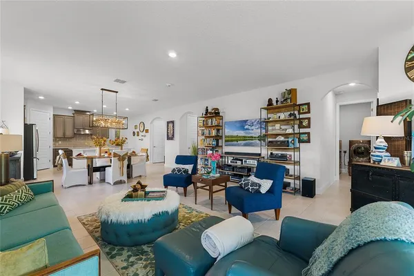 a living room with furniture kitchen view and a table