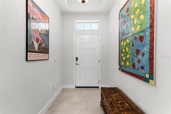 an entryway with painting on the wall