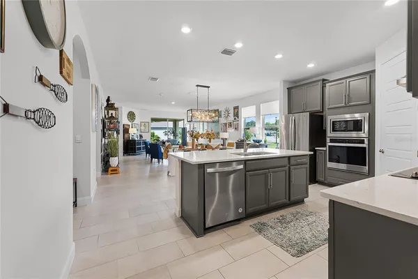 a kitchen with stainless steel appliances granite countertop a refrigerator and a sink