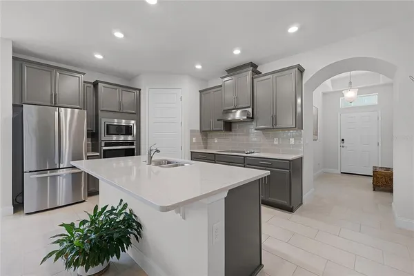 a kitchen with stainless steel appliances a refrigerator sink and stove